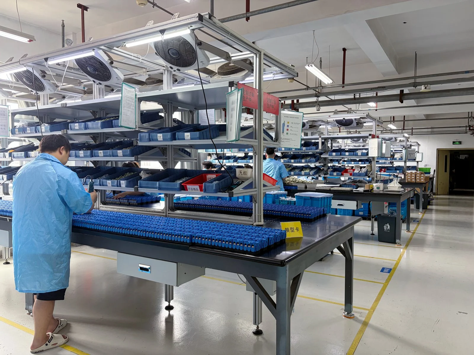 Switch assembly production line with operators at workstations